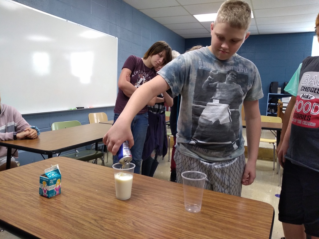 Middle school doing a lesson on energy drinks. Showing a fun reaction mixing milk and Red Bull.